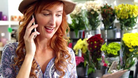 female florist taking order on mobile phone