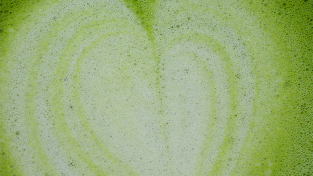 Close up of a heart latte art on a matcha latte