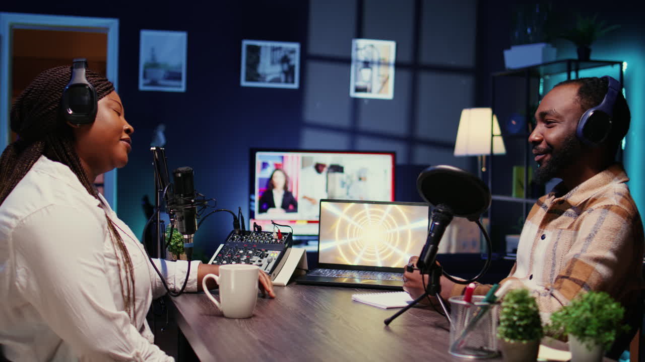 Woman radio show presenter having live conversation with man, recording discussion for audience