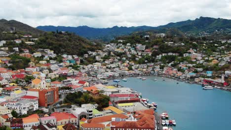 aerial establish of vibrant yellow orange roof and facades of the carenage grenada