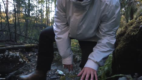 person hiking in a forest stream