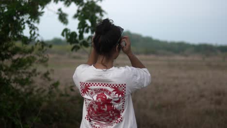 woman in a casual t-shirt enjoys the scenic outdoors during a cloudy day