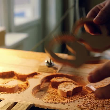 wood cut machine with drill is cutting out wooden molds