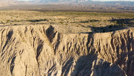 Aerial-exploration-unveils-the-enchanting-Badlands-during-an-epic-sunset-in-the-California-mountains