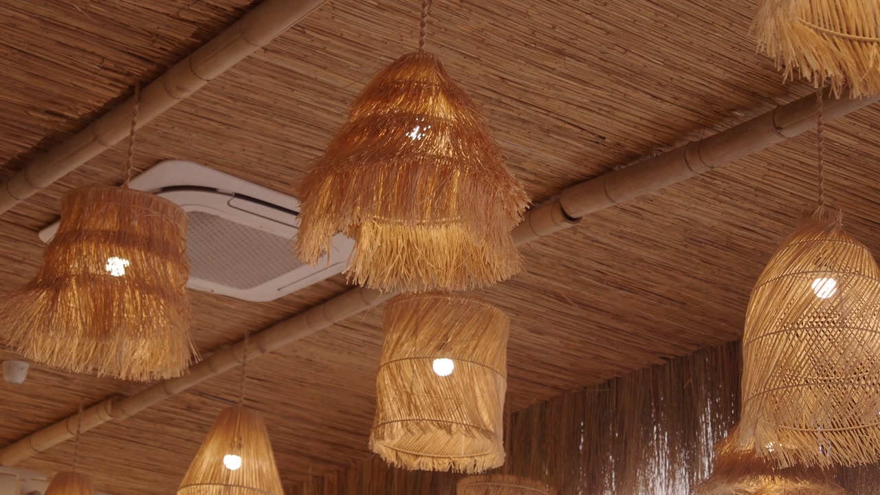 Rustic Woven Straw Lamps Hanging from a Bamboo Ceiling