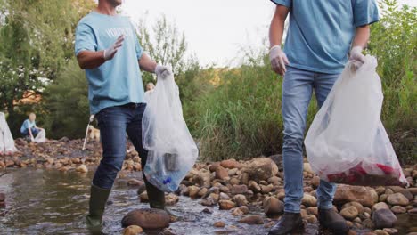 mid adults volunteering during river clean-up day