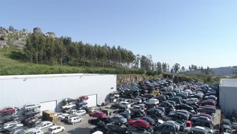 aerial view of a junkyard and large group of wrecked cars