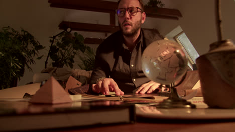 man reading a book in a cozy home study