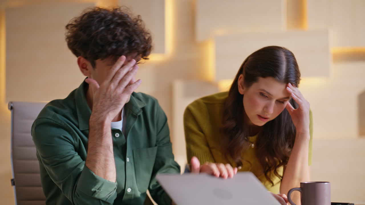 Couple Facing Frustration and Stress While Working on Laptop