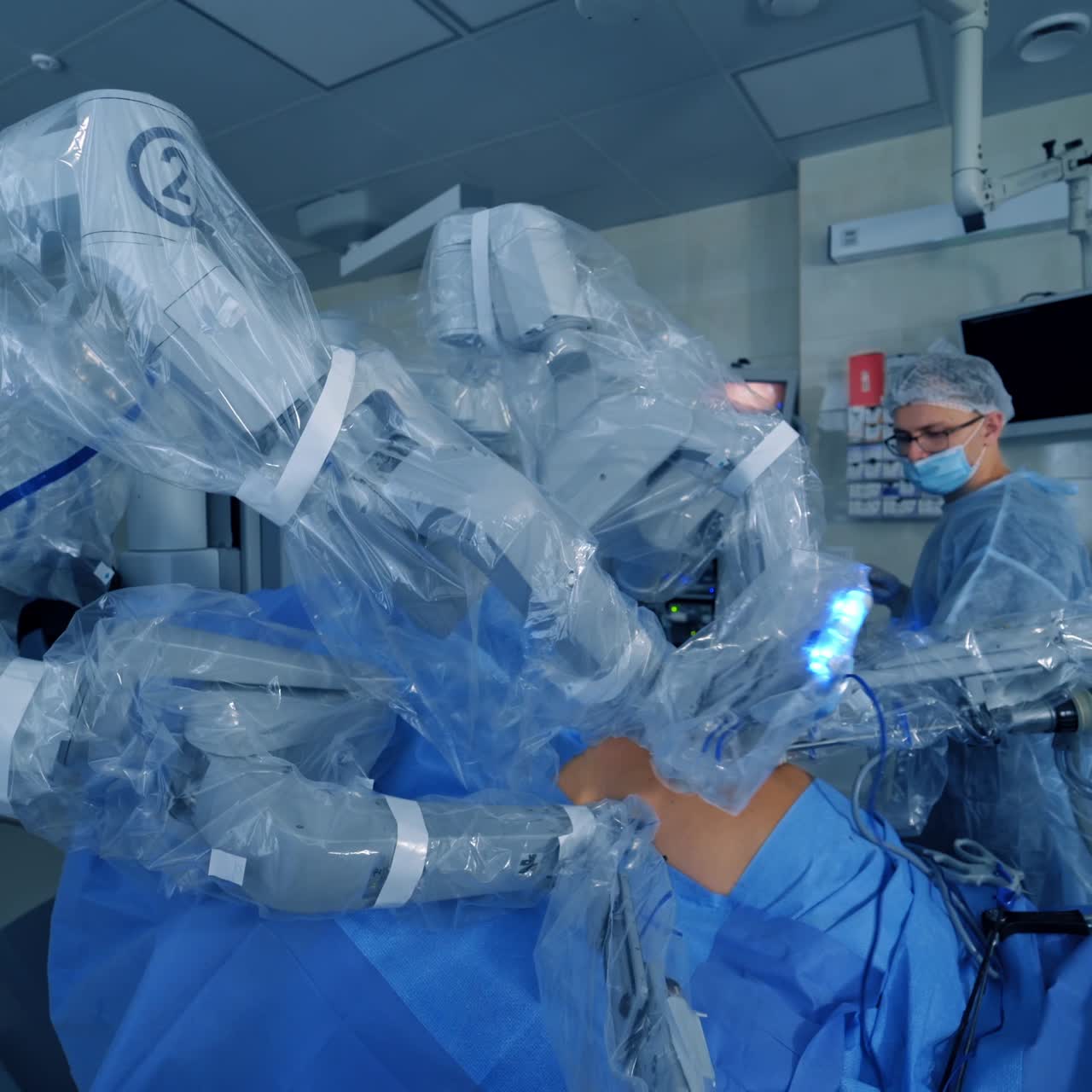 Robot with surgical arms in operating room. Modern surgery with robotic technology equipment in hospital. Minimally invasive surgical innovation.