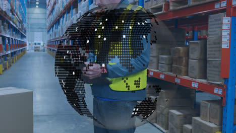 spinning globe against caucasian male worker writing on clipboard at warehouse