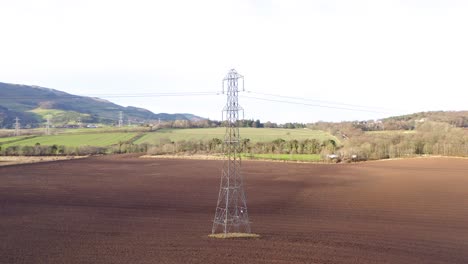 transmission tower in a field in outer edinburgh, with surrounding farms and scenic backdrop