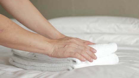 hotel house keeping service brings towels to the bed room