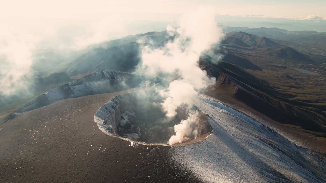 Aerial Fly establishing Mount Asama Volcano smoking slow, Japanese nature drone view