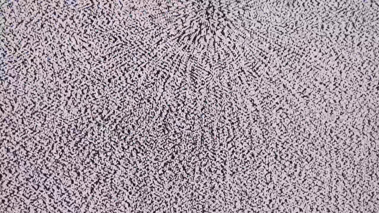 검은색과 색의 정적 소음과 중앙 스푸트는 루프로 상단 가장자리를 가로질러 움직입니다.