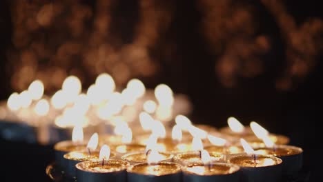 Background-of-tea-cup-glitter-Candles-Lights-shines-yellow-gold-bright-for-celebration,-religion,-anniversary-Festival