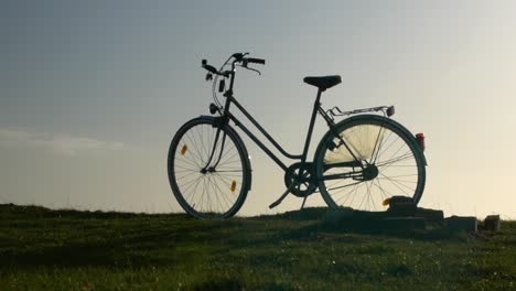 a bike is standing on a field, blue sky is in the background