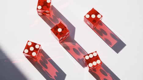 red gambling craps casino dice in bright sunshine with moving shadow