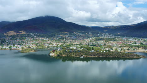 mona hobart art museum and tasmania skyline view aerial flyover, australia 4k