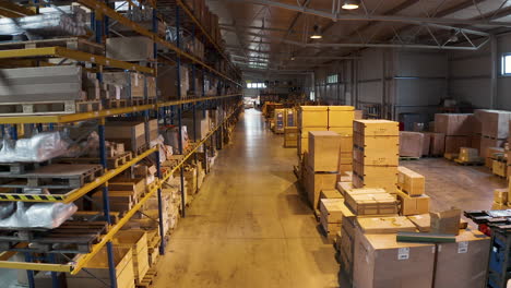 Warehouse-aisles-13-and-14-with-stacked-cardboard-boxes,racks,pallets