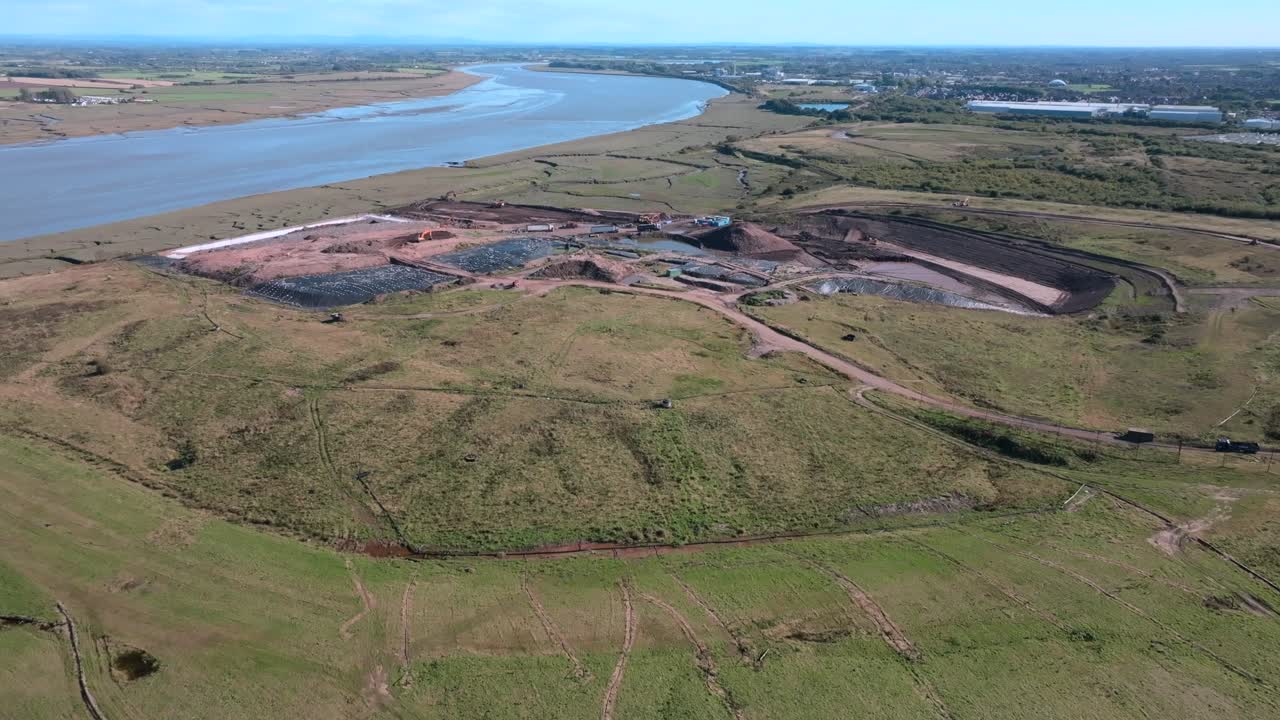 Approaching Large Landfill Site Next To River Wyre. Jameson Road Landfill And Recycling Site, Fleetwood, UK