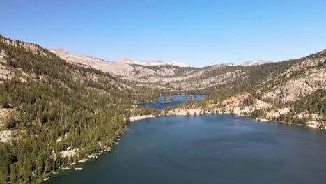 wind dances on the water of lower echo lake in tahoe as the drone fly's west towards mountains