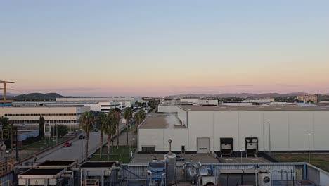 chimney without smoke emission. chemical factory with chimney expelling water vapor. landscape shot with sunset in chemical factory and a quarter moon.