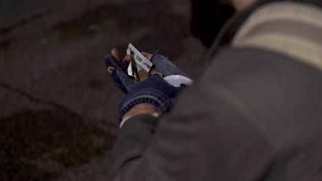 beggar hands counting his money- close up