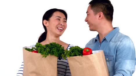 Asian-smiling-couple-holding-food-bags