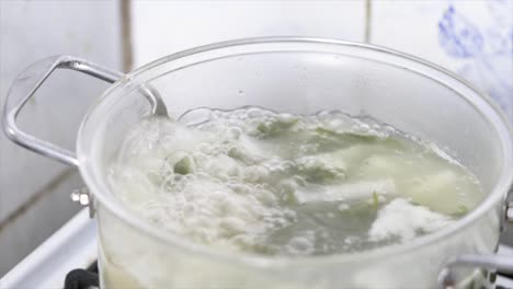 close up boiling soup in a glass pot