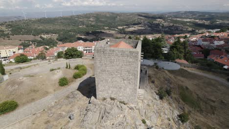 drone orbit around ancient guarda castle reveals city of guarda in background