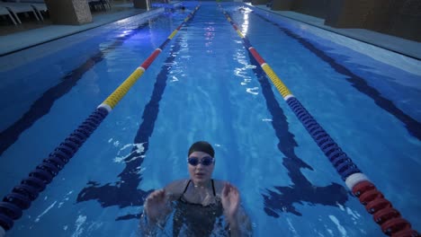 sporty young woman swimming in pool