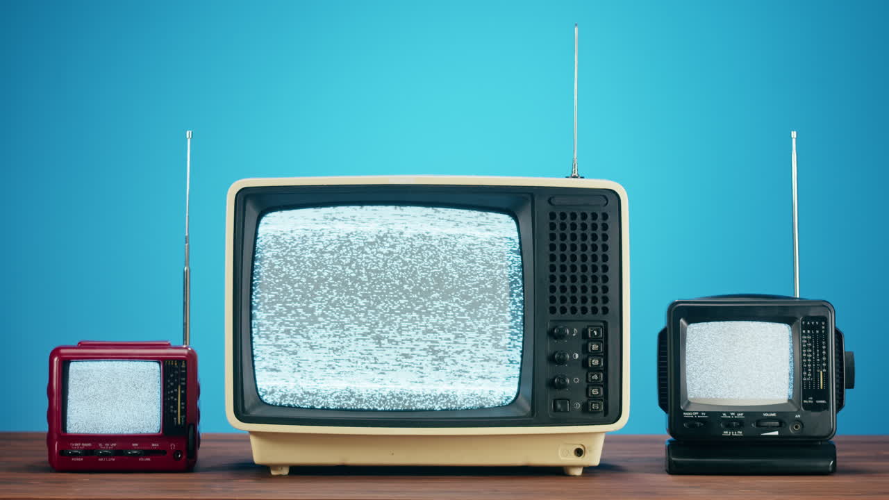 A Collection of Retro Televisions Displaying Static