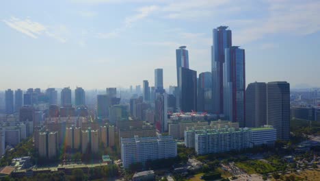 Drone-shot-traveling-forward-above-the-Han-river-toward-the-a-business-district-with-skyscrapers-in-Seoul-city-during-the-day