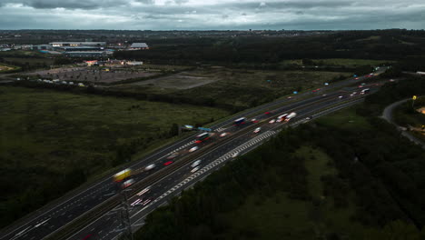 Establishing-Aerial-Drone-Hyperlapse-of-M1-Motorway-on-Cloudy-Morning-with-Light-Trails-Near-Leeds-UK