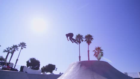 a bmx bike rider executes two high jump and rides the walls at a skatepark 1