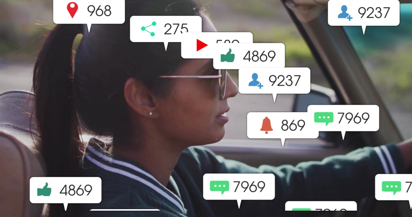 Conductora conduciendo en el interior de un coche, con iconos flotantes de notificaciones de marketing en redes sociales
