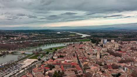 Bird's-eye-view-of-Avignon,-with-clouds-adding-a-touch-of-drama-to-its-skyline.