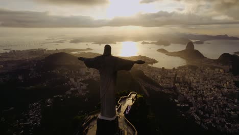 christ the redeemer statue overlooking rio de janeiro at sunset
