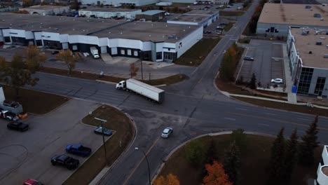 a semi-truck is making a left turn at an intersection, revealing an aerial view of downtown calgary