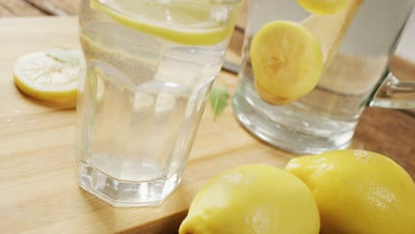 video of glasses with lemonade and lemons on wooden board