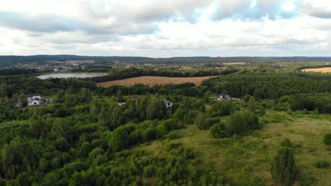 flight over green forest and meadow in kolbudy in pomeranian district