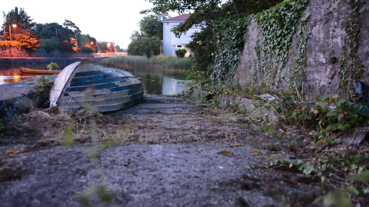 Old Upside Down Canoe Sitting Beside Water