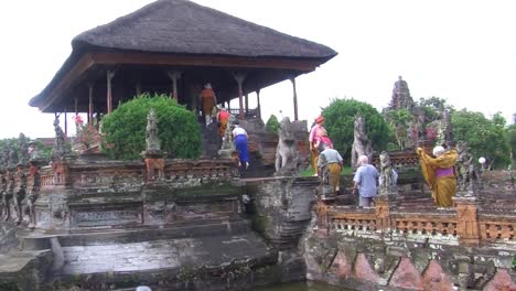 tourists entering the kertha gosa pavilion (the hall of justice) in bali, indonesia.