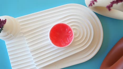 pink lip balm on a white plate