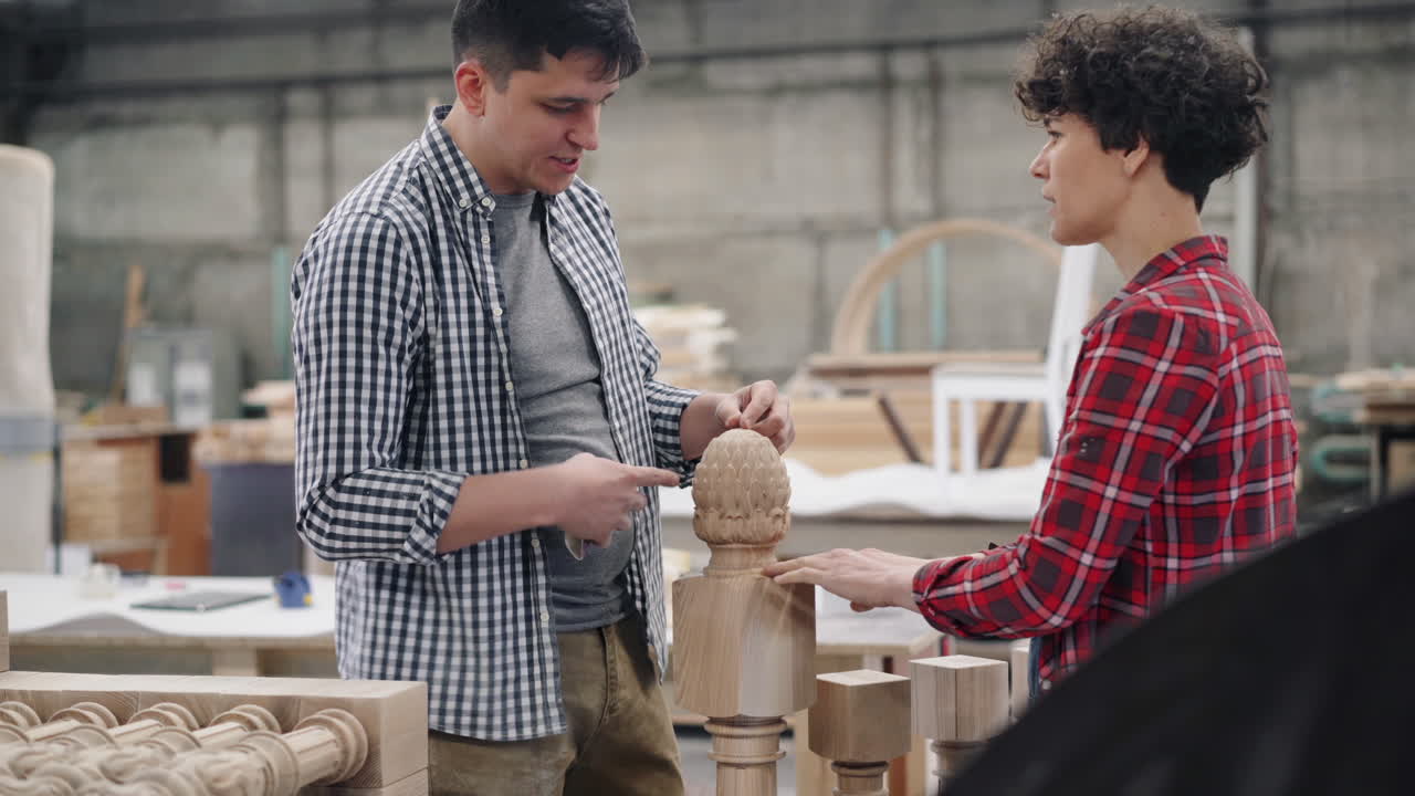 Woodworkers Inspecting Wooden Details in Workshop