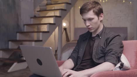 young man working on a laptop at home