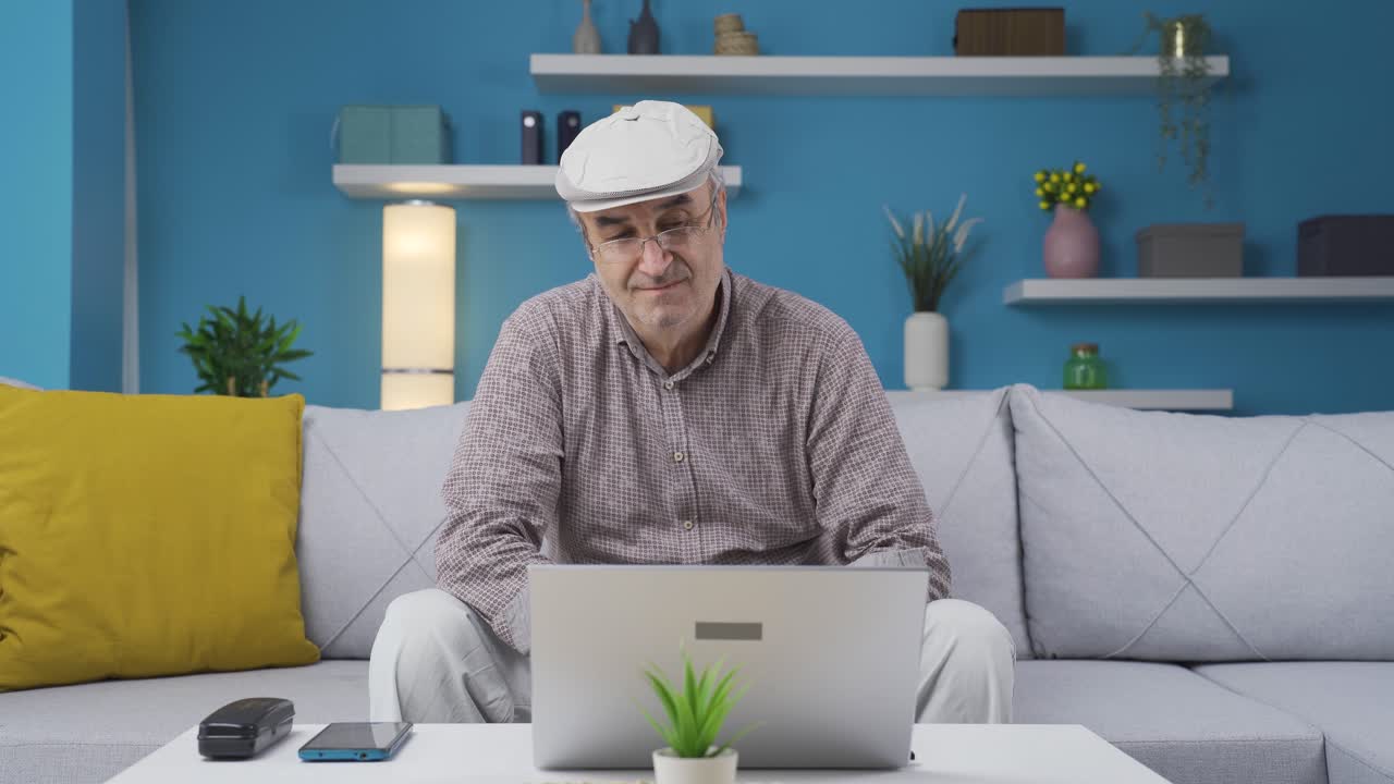 Bored old man at the computer. Thoughtful.
