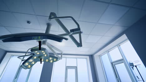 switched on advanced lamps on the ceiling of surgery room. illumination equipment in modern hospitals from low angle view.