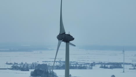 the windmill rotates and produces green energy during the winter